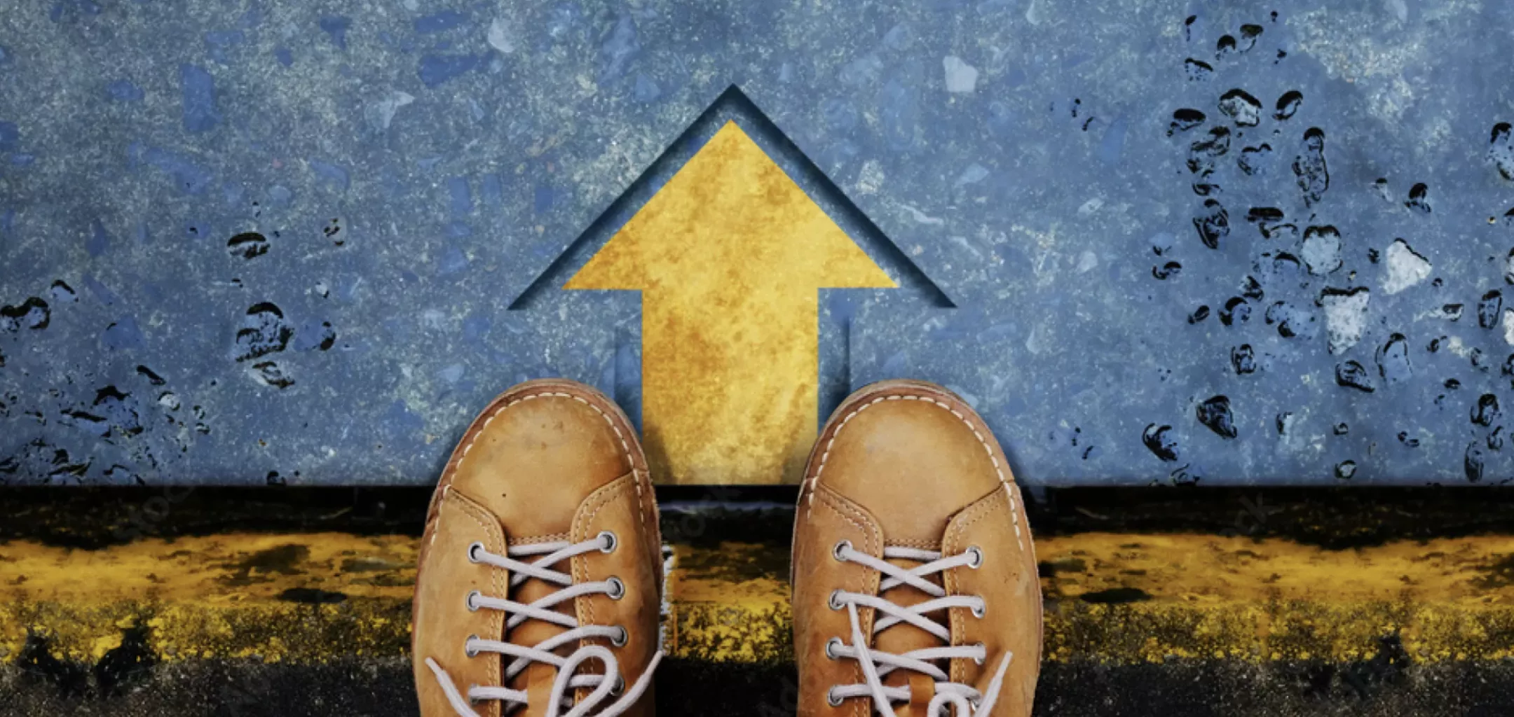 A pair of brown boots standing on a textured blue surface with a yellow arrow pointing forward.